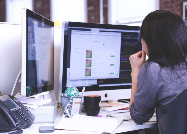 Student working at a computer in an office